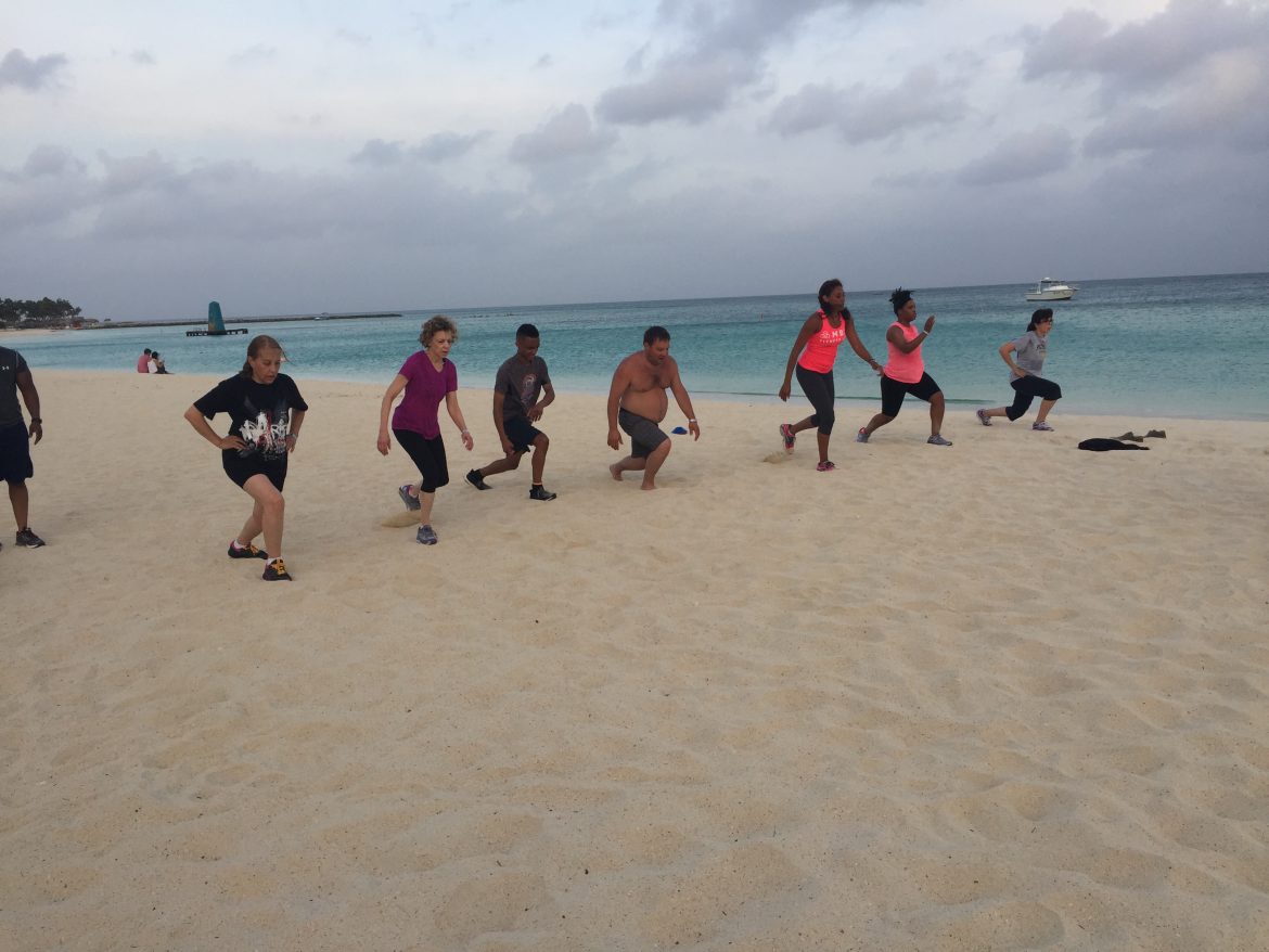 Lunges with corporate friends on beach