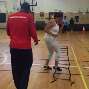 Learning footwork with personal fitness trainer